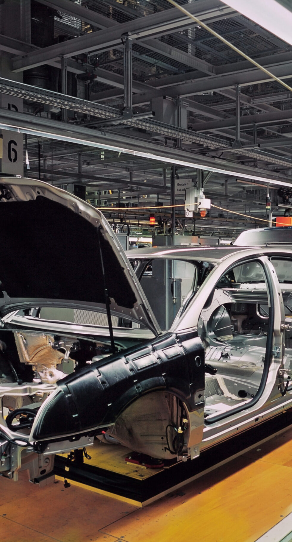 car production line with unfinished cars in a row