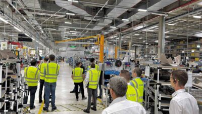 A group of people walking through a factory