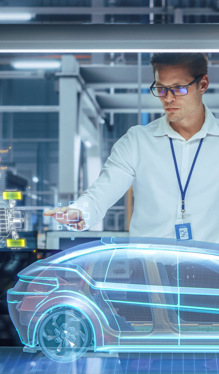 Green Energy Car Design: Automotive Engineer Using Augmented Reality Hologram to Construct 3D Model of High-Tech Electric Vehicle Optimizing Battery Efficiency. Automated Robot Arm Manufacturing
