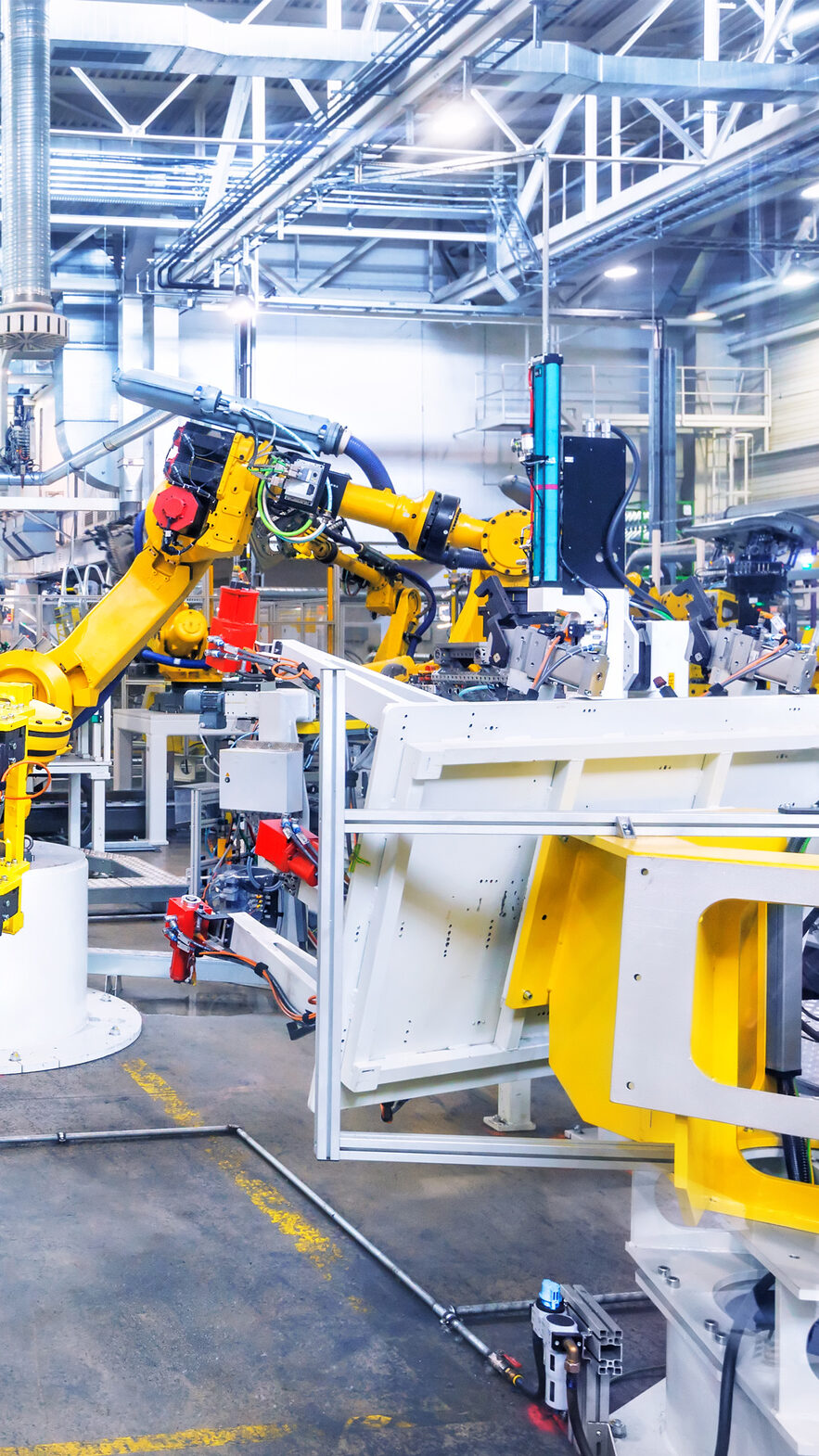 robotic arms in a car plant